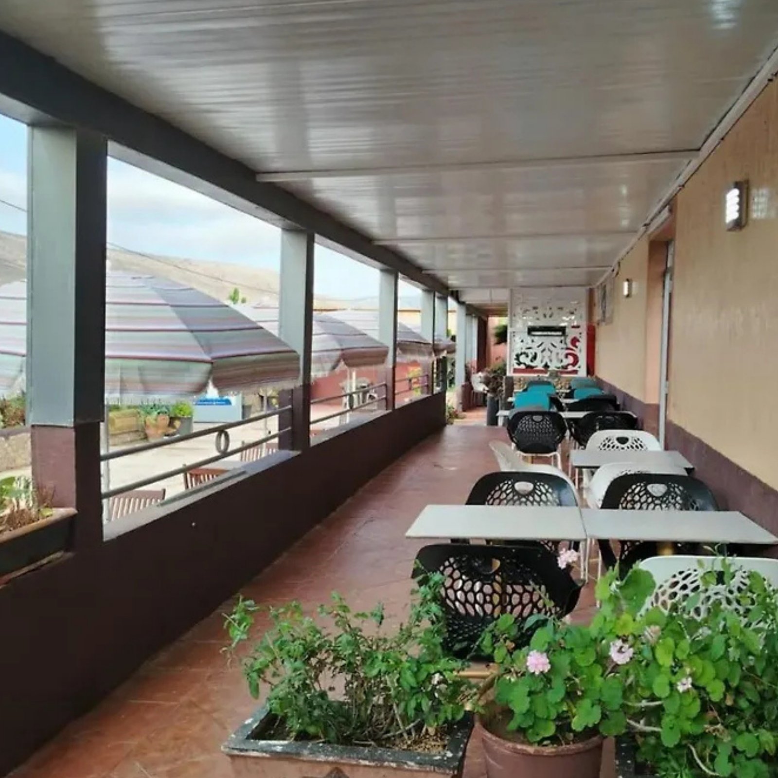 Covered terrace lounge with seating at La Bananeraie SurfCamp, Tamri, Morocco