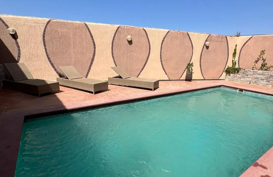 Swimming pool and sun loungers at La Bananeraie SurfCamp
