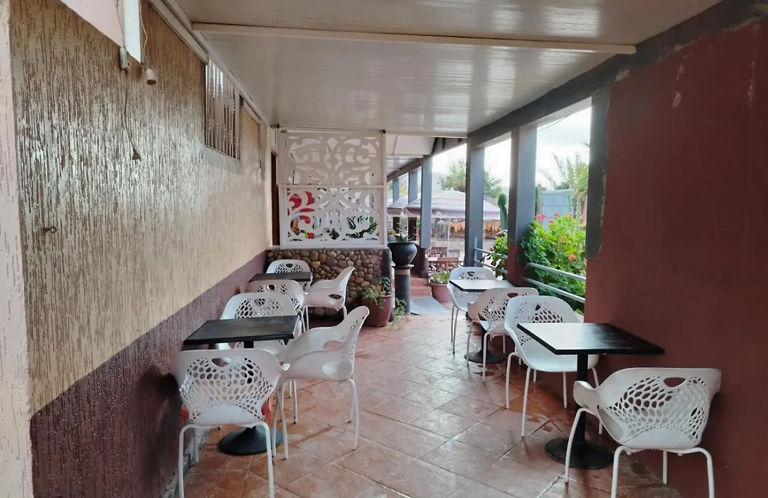 Outdoor cafe seating with mountain view at La Bananeraie SurfCamp