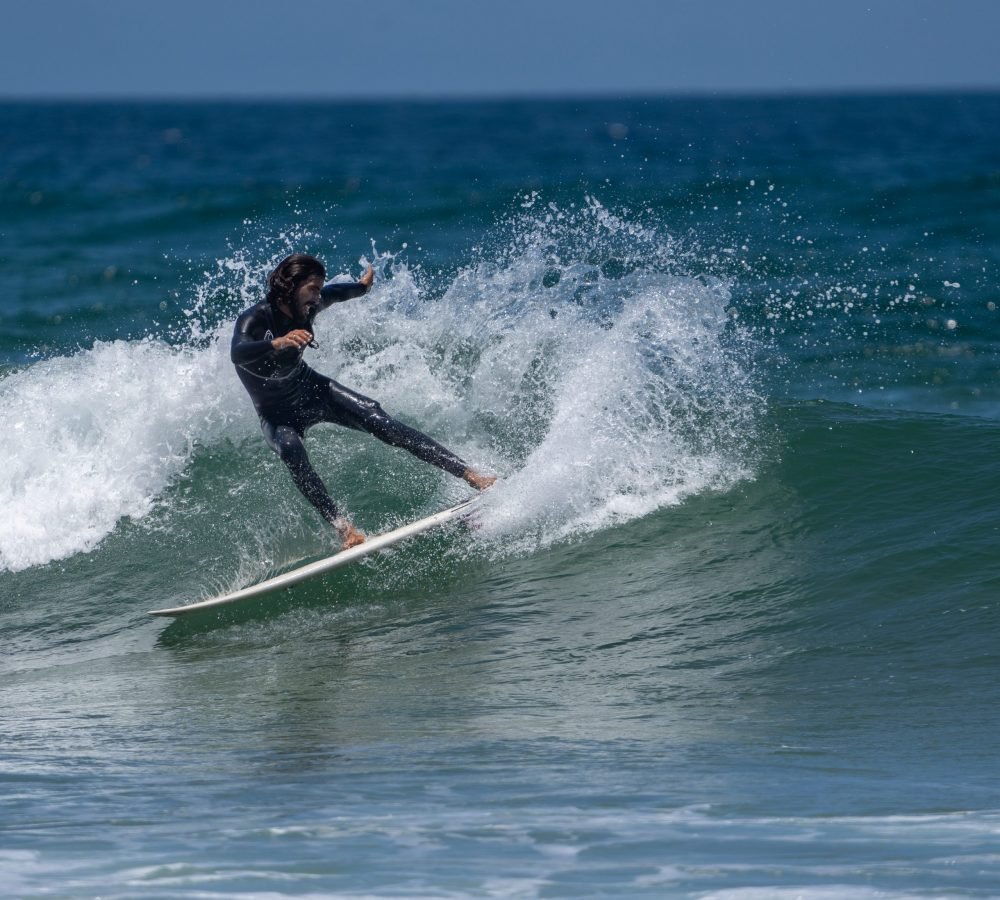 Surfer riding a wave, captured by a MarySol photographer